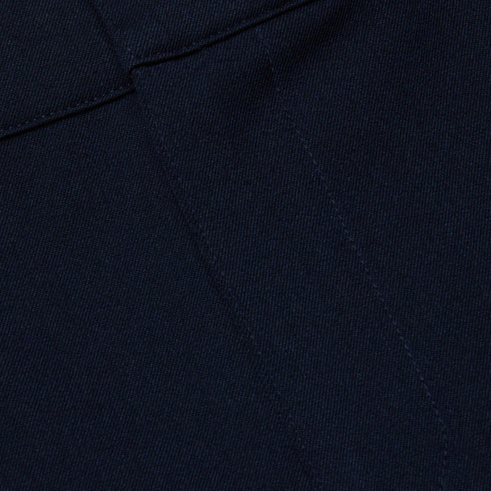 Close-up of midnight navy stretch fabric from the Ketra Bootcut Trouser, featuring visible stitching and seam lines. The material has a smooth yet slightly textured appearance.