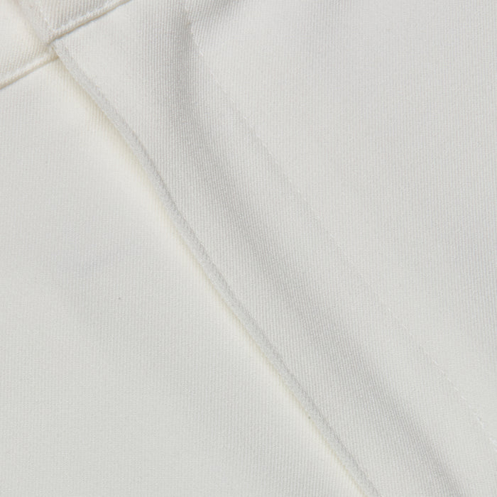 Close-up of the white stretch fabric from the Ketra Bootcut Trouser, featuring a visible seam and stitching. The texture and weave of the material are clearly shown.