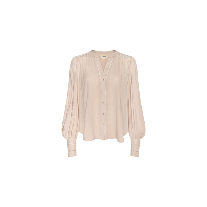 The Kiera Blouse is a light pink bohemian top featuring a V-neckline, button-down front, gathered shoulders, and wide blouson sleeves crafted from textured rayon, shown against a plain white background.
