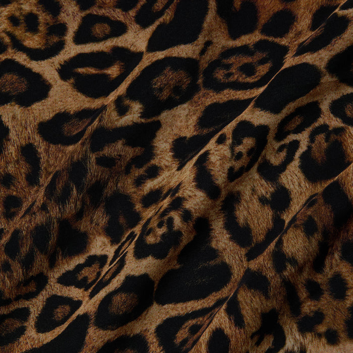 Close-up of the Klaire Cover-Up Skirt, crafted from viscose chiffon with a brown and black leopard print pattern, highlighting the irregular dark spots and delicate folds in the material.