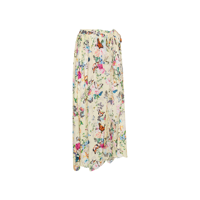 The Klaire Cover-Up Skirt is a long, flowy wrap maxi skirt crafted from cream-colored viscose chiffon, adorned with a vibrant floral and butterfly print, and designed with a gathered waist and wrap-style front.