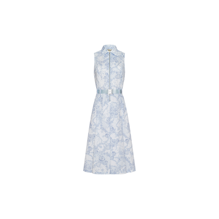 The Kylo Shirt Dress is a sleeveless, light blue and white cotton blend shirt dress with a floral print, button-down front, and matching belt at the waist, displayed on a plain white background.