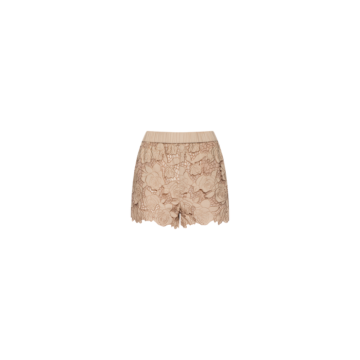 The Laina Eyelet Short features a beige lace design with a scalloped hem and delicate floral patterns, crafted in a lightweight style and presented in an almond tan shade against a plain white background.