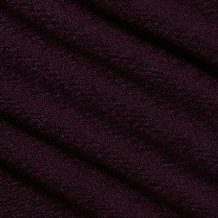 Close-up of the Lani Turtleneck’s deep purple fabric with a diagonal ribbed texture and soft, matte finish—ideal for Fall 2026. The material appears smooth, with gentle shadows accentuating the folds.