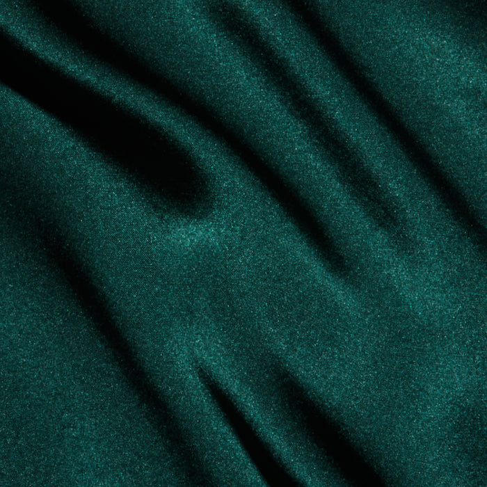 Deep green silk with a smooth, softly wavy drape and subtle sheen, evoking the rich texture and elegance of the Lexi Silk Camisole’s bias-cut silhouette and adjustable straps.