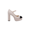 The Lilles Platform Pump is a beige Mary Jane style shoe with a square toe and chunky block heel, highlighted by a black cap toe, shown against a plain white background.