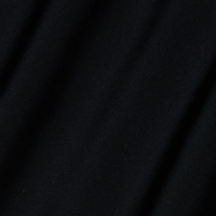 Close-up of black fabric from the Lilou One-Piece Swimsuit, featuring a v-wire plunge design with subtle diagonal folds and a smooth texture.