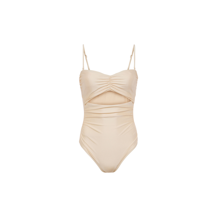The Lily Cut-Out One-Piece Swimsuit in beige features thin adjustable straps, a ruched bodice, and a cutout detail below the chest. Designed with a smooth, fitted silhouette and displayed against a plain white background.