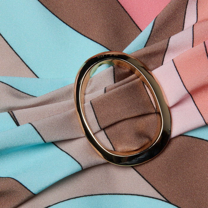 A close-up of the Lisa Plunge One-Piece Swimsuit showcases its abstract swirl print in pastel blue, brown, and pink tones, gathered elegantly by an oval-shaped gold metal buckle.