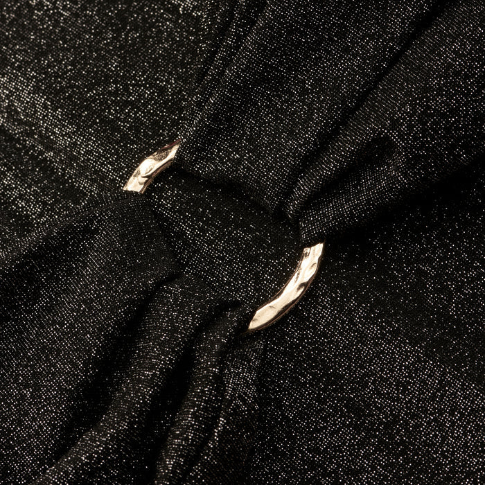 Close-up of the Lisa Plunge One-Piece Swimsuit’s shimmery black fabric, gathered by a shiny silver metal ring that creates soft folds and elegant texture.