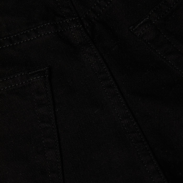 Close-up of the Lissania Jean Short in black denim, showcasing visible stitching, pocket seams, and tailored details that highlight the fine craftsmanship of the fabric.