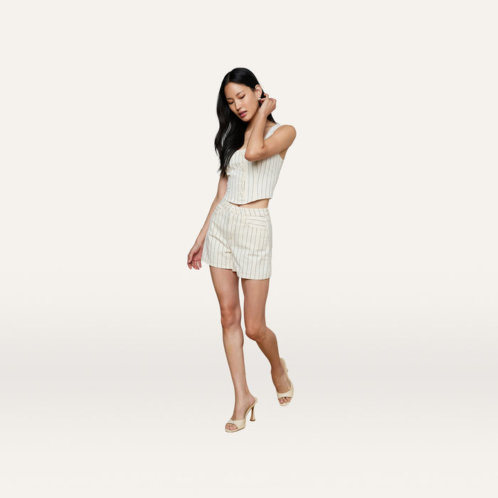 A woman with long dark hair wears the Lissania Short and matching nautical vest with heels, standing against a plain white background.