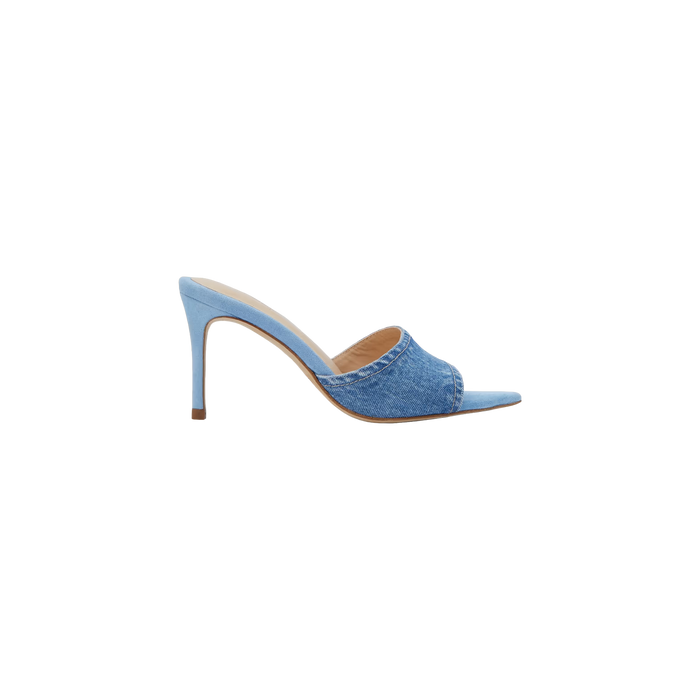 The Lolita Denim Open-Toe Mule features a light blue denim upper, a high heel, a peep-toe design, and a single wide strap, shown from the side against a plain white background.