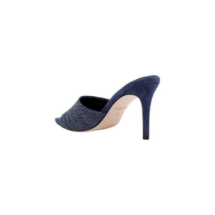 The Lolita Denim Open-Toe Mule, featuring a denim upper and a blue suede stiletto heel, is shown from the side and slightly behind against a white background.
