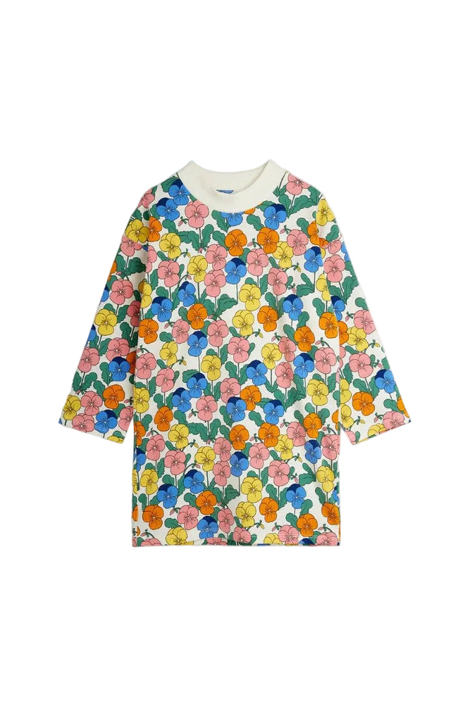A long-sleeve crewneck dress featuring a vibrant, all-over floral print with pink, blue, yellow, and orange flowers on a white background, finished with a solid cream collar.