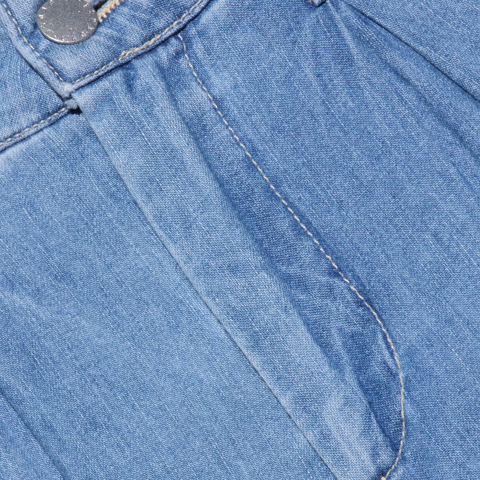 Close-up of the front of the Lorenza Palazzo Jean in blue denim, featuring the waistband, button, zipper fly, and detailed stitching on a high-rise palazzo leg.