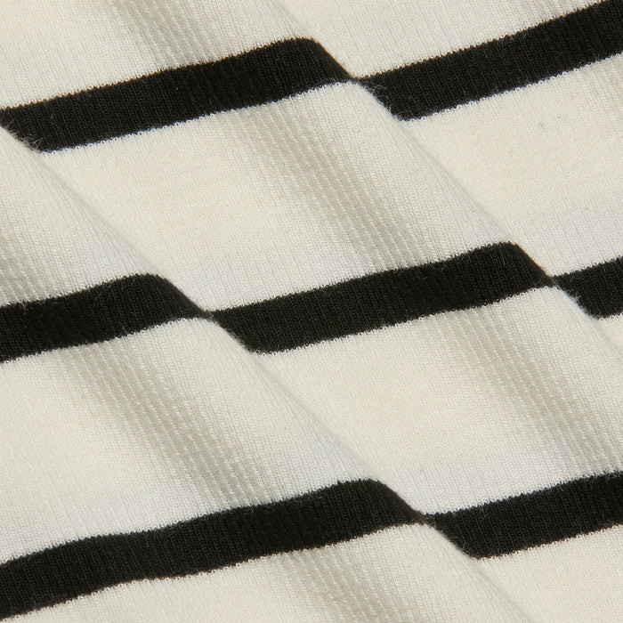 Close-up of the Lucille Striped Boatneck Top, highlighting its ribbed fabric with timeless black and white stripes arranged diagonally to showcase the texture and pattern.