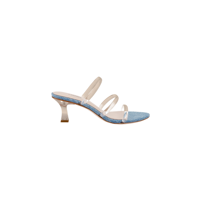 The Ludovica Kitten-Heel Sandal features three clear straps, a blue denim footbed, and a short clear flared heel, capturing the charm of a denim mule. Displayed on a white background, this style combines minimalist shoe design with contemporary materials.