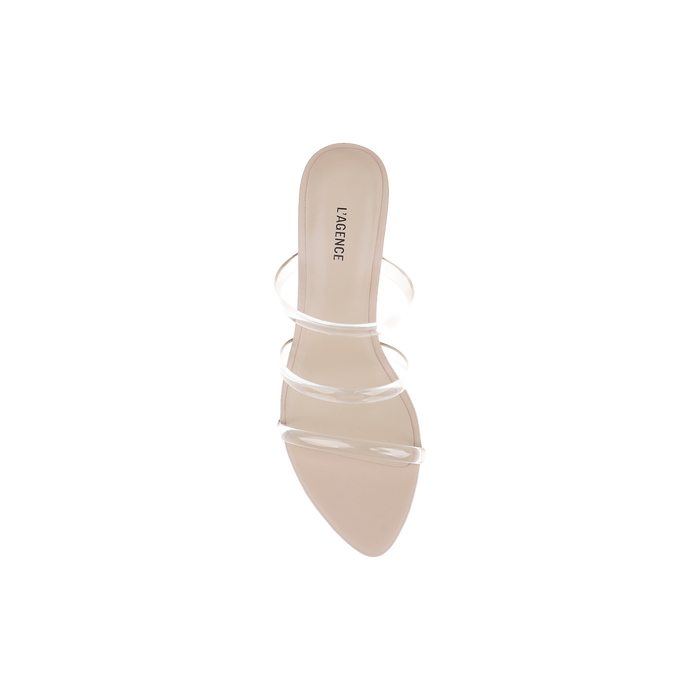 A single beige Ludovica Kitten-Heel Sandal with a pointed toe and clear vinyl straps displays the LAGENCE logo on the insole, set against a white background; this minimalist mule showcases sleek plastic bands for a contemporary look.