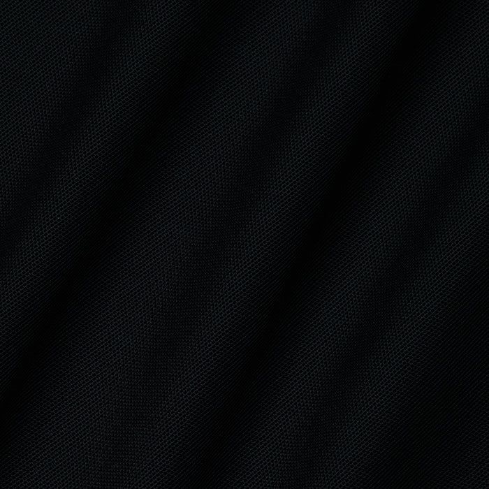 Close-up of the black textured fabric of the Mahe Mesh Cover-Up Skirt, featuring subtle diagonal lines and a fine mesh pattern reminiscent of a sheer poolside cover-up, creating depth and soft shadows across the surface.