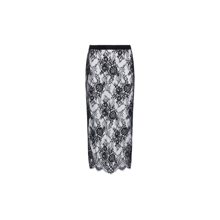 The Makena Lace Pencil Skirt is a knee-length skirt with a black floral lace overlay on white fabric, featuring a scalloped hem and a black waistband, displayed on a plain white background.
