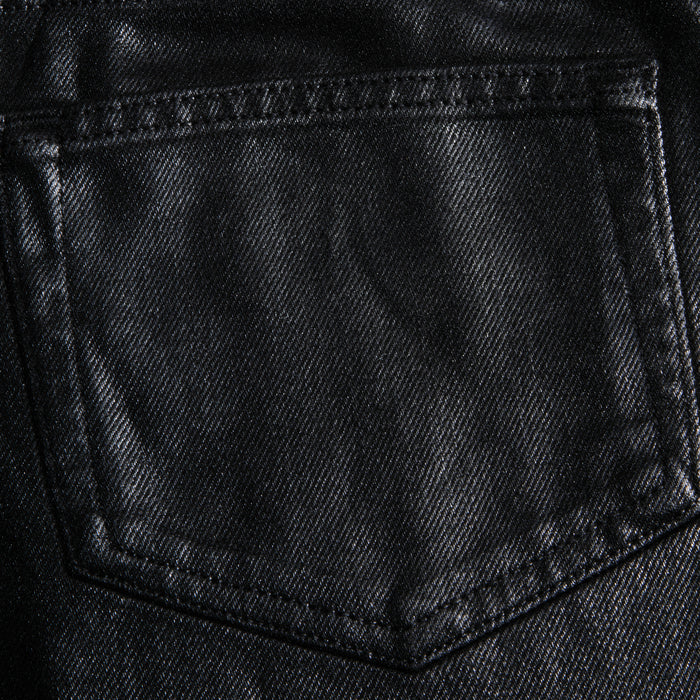 Close-up of the Mallis Coated Bow-Leg Jean pocket, highlighting the black coated denim texture and detailed stitching.