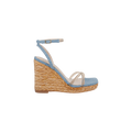 The Malone Wedge Espadrille is a single bohemian sandal featuring a woven straw heel, light blue ankle strap, and clear toe straps, displayed in profile against a plain white background.