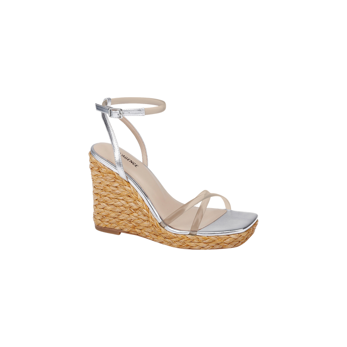 Malone Wedge Espadrille featuring a silver design with a braided raffia wedge platform, clear front strap, ankle strap with buckle, and an open square toe, displayed on a plain white background.