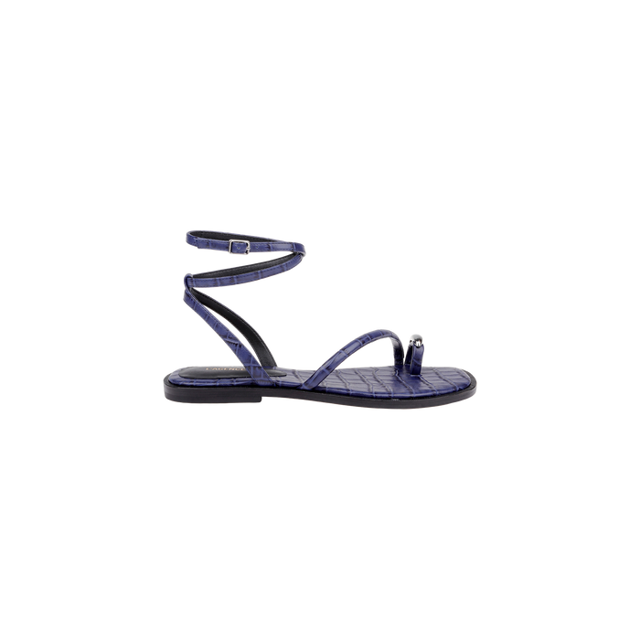 The Mariana Leather Sandal is a purple, flat leather sandal with a textured pattern, shown in a side profile view on a plain white background. It features a toe loop, single front strap, and an ankle strap with buckle closure.