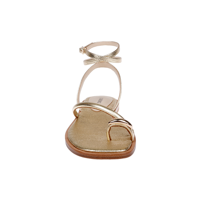 The Mariana Leather Sandal, crafted from gold lizard-embossed leather, features a toe loop, slender ankle tie strap, and a minimalist metallic design, displayed from the front on a white background.
