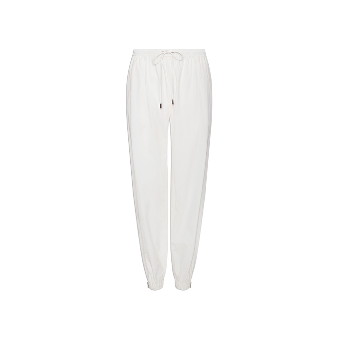 The Mariko Jogger in ivory, made from water-repellent nylon, features an elastic waistband, drawstring, and elastic cuffs, and is displayed on a plain white background.
