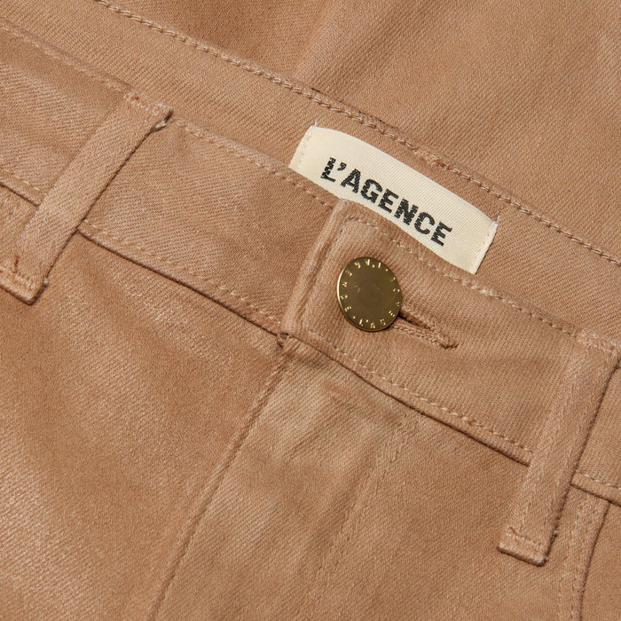 Close-up of the Marty Coated Flare Jean in light brown, featuring a gold button and a visible L’AGENCE label above the waistband.