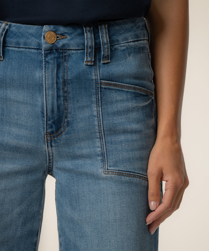 Light blue high-rise wide-leg jeans with brass button, belt loops, and visible stitching detail.