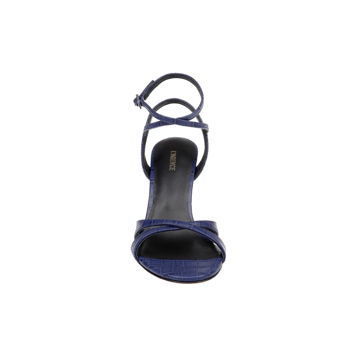 The Miranda Leather Sandal is a single navy blue, open-toe shoe with an ankle-wrap strap and a textured pattern, shown from above against a plain white background. This elegant design complements evening gowns perfectly.