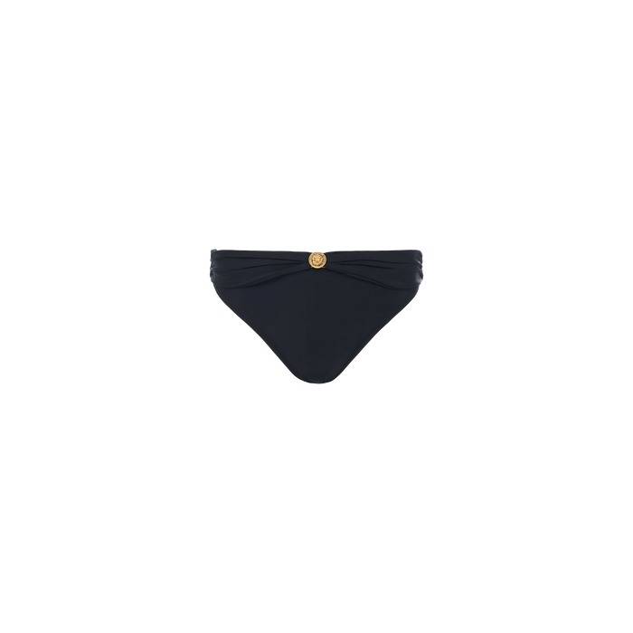 The Miya Bikini Bottom, shown on a plain white background, features a black design with a ruched waistband and a gold coin detail at the center.
