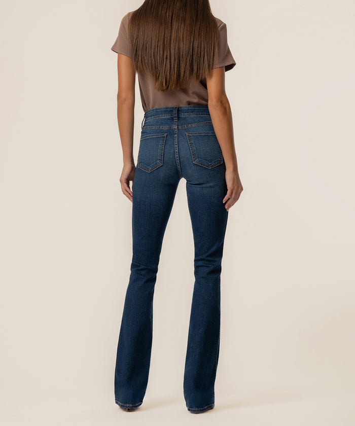 Blue bootcut jeans with high-rise waist, shown from back on model wearing tan t-shirt.