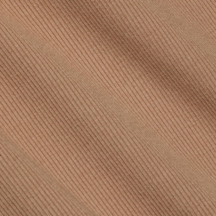 Close-up of the Nica Scoopneck Bodysuit in light brown corduroy, showcasing its diagonal ridges and soft, textured material. The image highlights the stretch rib weave pattern and detail, making it an ideal base layer.