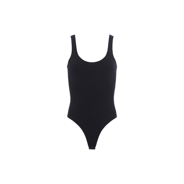The Nica Scoopneck Bodysuit is a plain black one-piece with a scoop neckline, high-cut legs, and a cheeky silhouette, displayed on a white background.