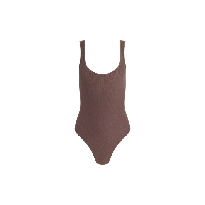 The Nica Scoopneck Bodysuit is a sleeveless brown bodysuit featuring high-stretch rib fabric, a sculpted fit, and high-cut leg openings, displayed on a plain white background.