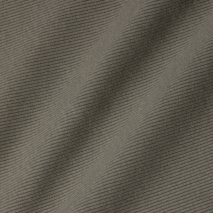 Close-up of grey ribbed fabric with diagonal ridges and subtle shadows highlighting the texture and folds, reminiscent of the sculpted fit featured in the Nica Scoopneck Bodysuit.