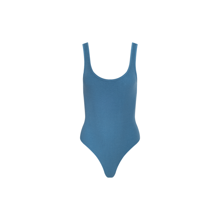 The Nica Scoopneck Bodysuit, a sleeveless blue one-piece with a sculpted fit and scoop neck, is displayed on a plain white background.