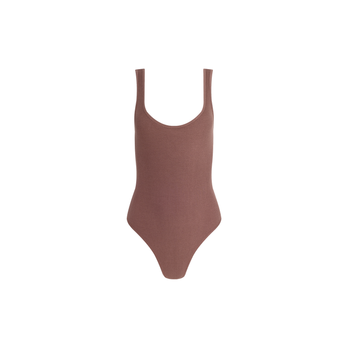 The Nica Scoopneck Bodysuit, in brown, is sleeveless with a scoop neckline and crafted from stretch rib fabric for a sculpted fit. It is showcased against a plain white background.