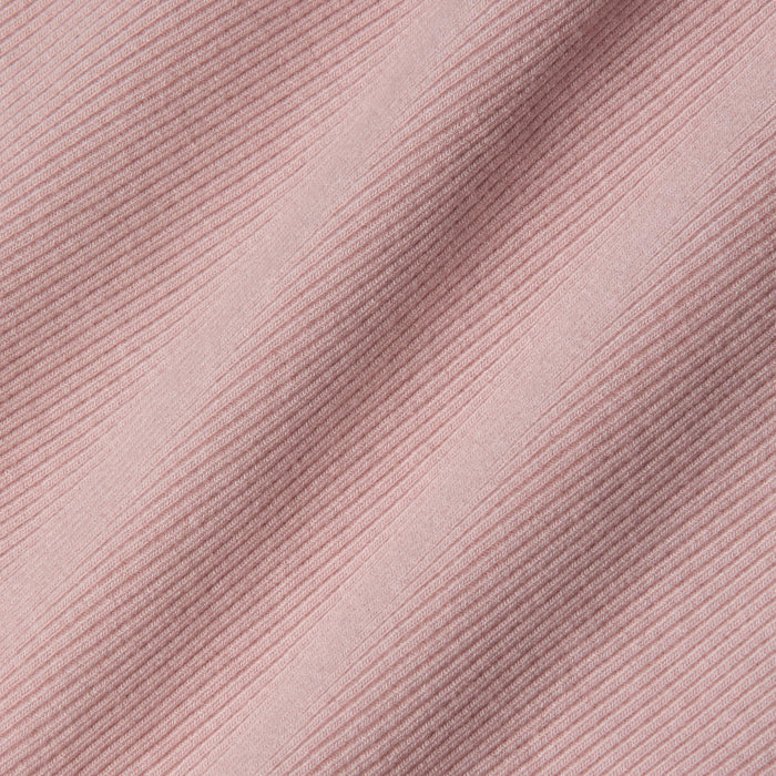 Close-up of pink ribbed fabric with diagonal textured lines and soft shadows, highlighting the detailed weave and pattern of this sculpted fit textile—perfect for the Nica Scoopneck Bodysuit.