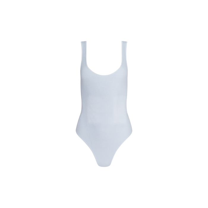 Nica Scoopneck Bodysuit in white, featuring a sleeveless design and high-stretch rib fabric, showcased against a plain light background.