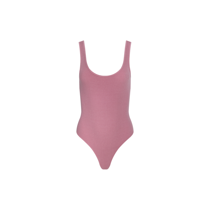 The Nica Scoopneck Bodysuit is a sleeveless, light pink one-piece crafted from stretch rib fabric, shown against a plain white background.
