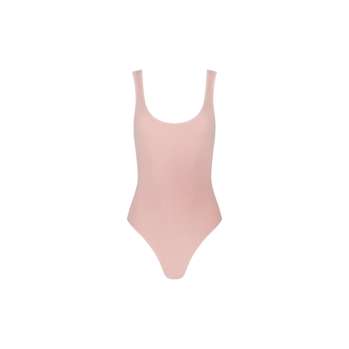 The Nica Scoopneck Bodysuit features a light pink hue, a sleeveless design, a scoop neckline, and high-cut legs, crafted from high-stretch rib fabric.
