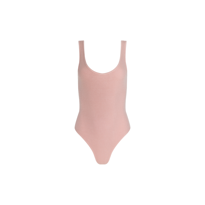 The Nica Scoopneck Bodysuit in light pink features a sleeveless, scoopneck design and is crafted from ribbed fabric for a sculpted fit, shown against a plain white background.
