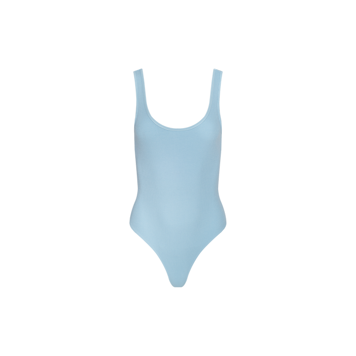 Light blue Nica Scoopneck Bodysuit with a sleeveless design, displayed on a plain white background. The smooth, fitted fabric showcases a sculpted silhouette and high-cut leg openings.