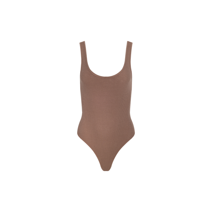 The Nica Scoopneck Bodysuit is a brown, ribbed sleeveless piece featuring a scoop neckline, high-cut legs, and a sculpted fit in high-recovery stretch rib fabric, shown against a plain white background.