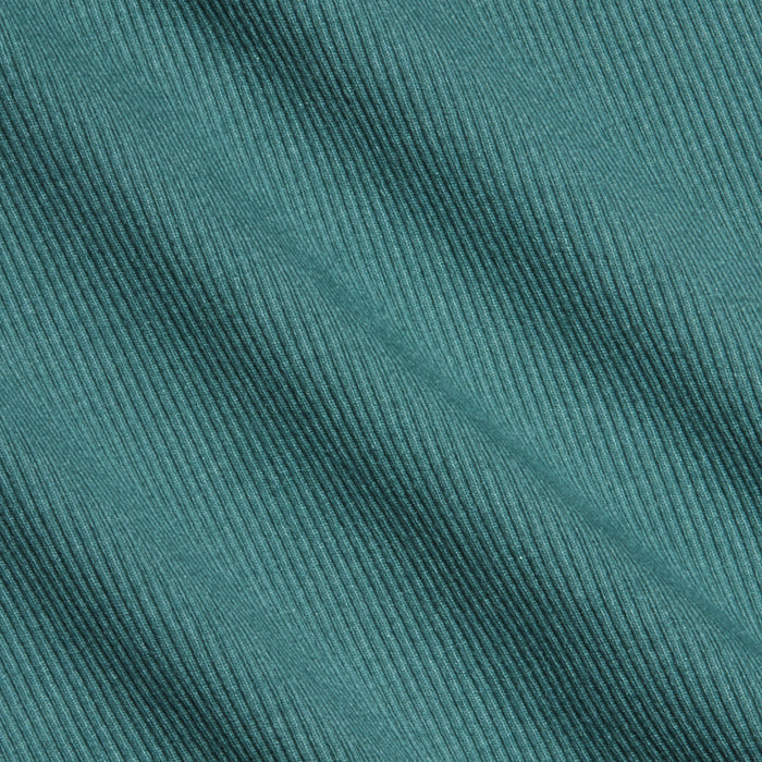 Close-up of teal high recovery stretch rib fabric with diagonal textured lines running across the surface. The material appears soft and features evenly spaced, raised ridges, making it ideal for a sculpted fit like the Nica Scoopneck Bodysuit.